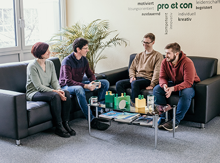 Group of four sitting pro et con employees